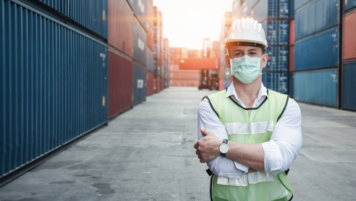 Factory worker with helmet and mask.