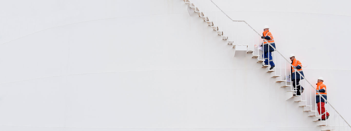 Factory workers walking up stairs.